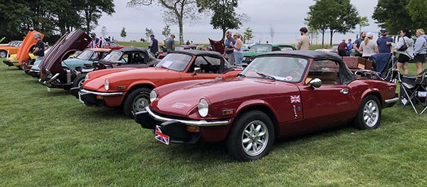 British Motorcars in Bristol. Picture of show field. Row of Triumph Spitfires with Narragansett bay in the background.